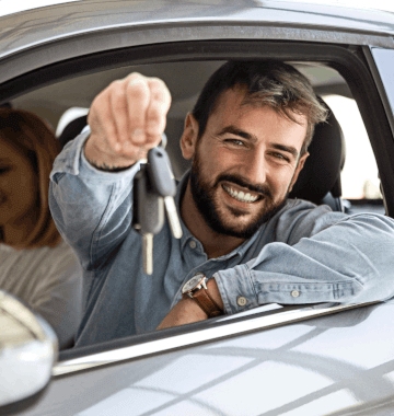 A man behind the wheel of a car